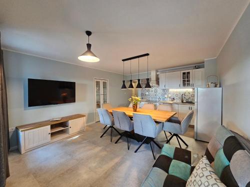a kitchen and dining room with a table and chairs at Old Village House Brda in Kojsko