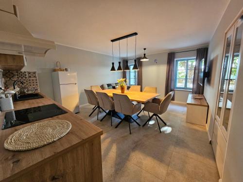 a kitchen and dining room with a table and chairs at Old Village House Brda in Kojsko