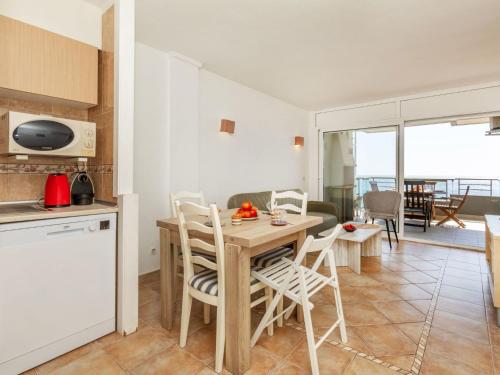 a kitchen and living room with a table and chairs at Apartment Vermell-8 by Interhome in Platja d'Aro