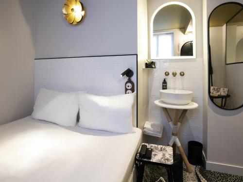 a bedroom with a white bed and a sink at ibis Styles Paris Gare De Lyon TGV in Paris