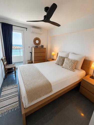 a bedroom with a bed with a view of the ocean at Oceanview Vega in Sisi