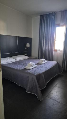 a bedroom with a large bed with blue curtains at Casa Mia in Cosenza