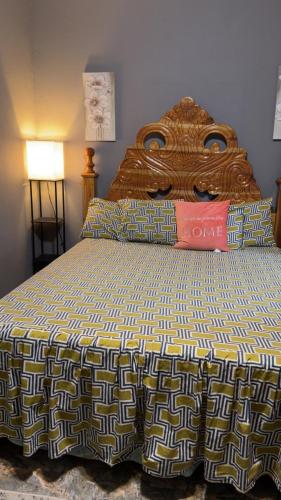 a large bed with a wooden headboard in a bedroom at Renee Oasis in Negril