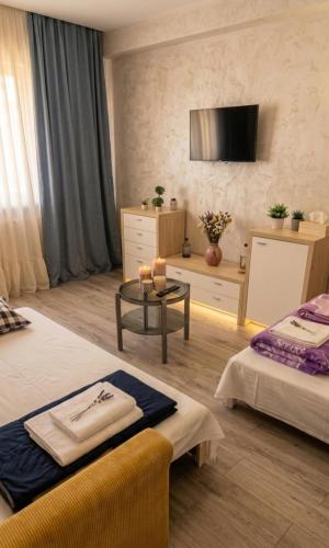 a hotel room with two beds and a table at Old City Cafe in Brăila
