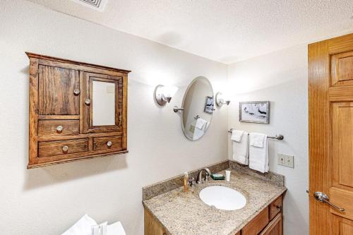 a bathroom with a sink and a wooden cabinet at Woodbridge 30 in Snowmass Village