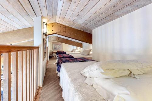 a bedroom with two beds and a wooden ceiling at Woodbridge 30 in Snowmass Village