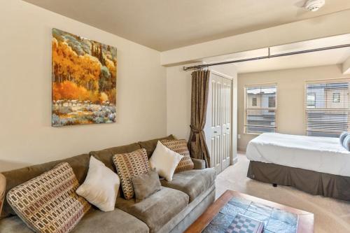 a living room with a couch and a bed at First Tracks 3203 in Steamboat Springs