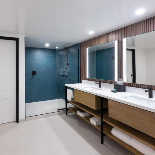 a bathroom with two sinks and a shower at Hilton Phoenix Resort at the Peak in Phoenix