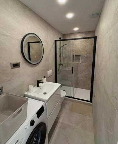 a bathroom with a sink and a washing machine at Brand new Big Blue in Jelsa
