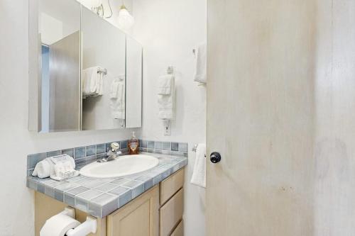 a bathroom with a sink and a mirror at Downtown Creekside Getaway in Ketchum
