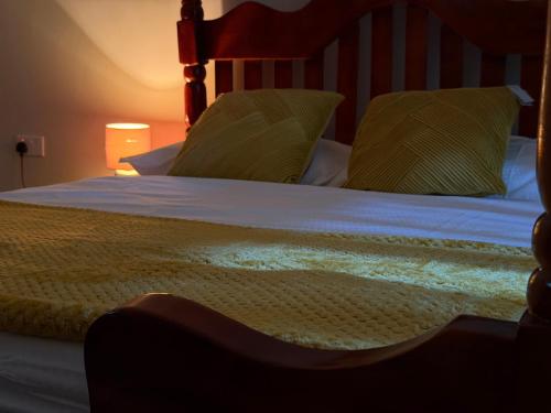 a bedroom with a bed with two pillows on it at Bubuli country club in Lyamutundwe