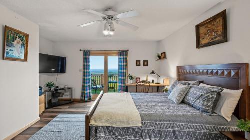 a bedroom with a bed with a ceiling fan at Stone Ridge by AvantStay in Albrightsville