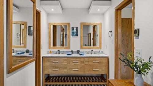 a bathroom with two sinks and two mirrors at Stone Ridge by AvantStay in Albrightsville