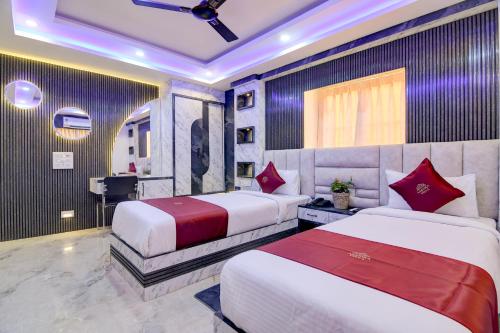 a hotel room with two beds and a sink at Hotel Aarnika Villa in New Town