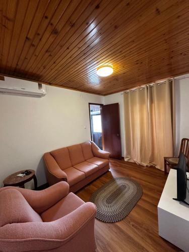a living room with a couch and a table at Ron House in São Caetano