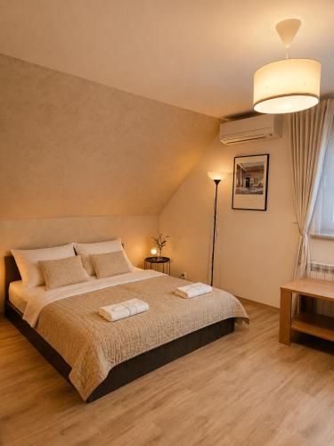 a bedroom with a bed with two towels on it at Brzegowy Relaks in Mszana Dolna