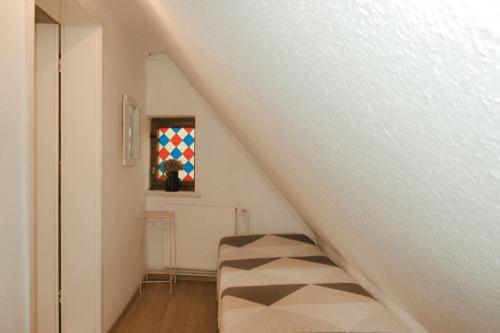 a room with a staircase with a couch in it at Ostsee-Apartment Wolgast in Wolgast