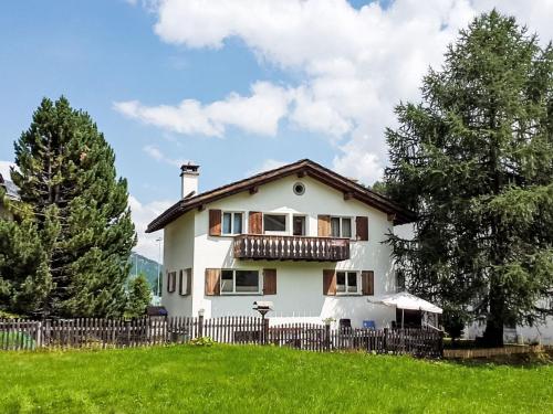 a white house with a fence in a field at Apartment Studio Chesa Marias by Interhome in Sils Maria