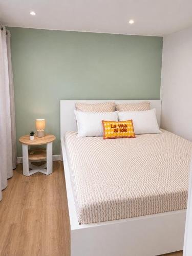 a bedroom with a bed and a small table at Chez Aurel et Ju in Tournon-sur-Rhône