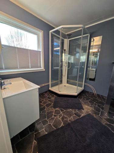 a bathroom with a shower and a sink at Oldervik Sea House in Tromsø