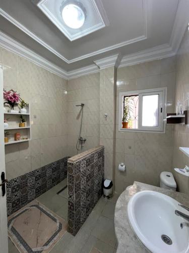 a bathroom with a large tub and a sink at Dar halouma in Tabarka