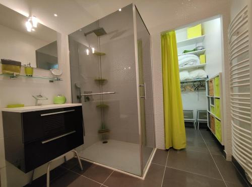 a bathroom with a shower with a glass door at Ancre Zen in Les Sables-d'Olonne