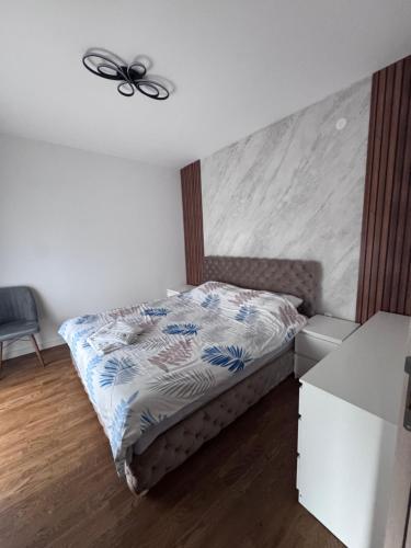 a bedroom with a bed and a ceiling fan at New Bubanj Apartment 3 in Kragujevac