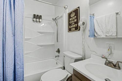 a white bathroom with a toilet and a sink at 410 e 45th ave unit 4 in Anchorage