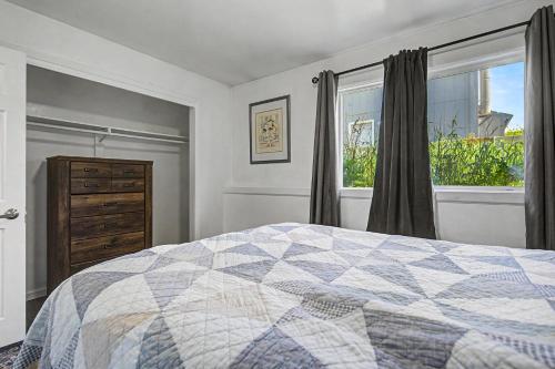 a bedroom with a bed and a window and a dresser at 410 e45th 2 bedroom apartment in Anchorage
