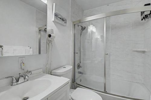 a bathroom with a shower and a toilet and a sink at 410 E 45th ave Unit 3 in Anchorage