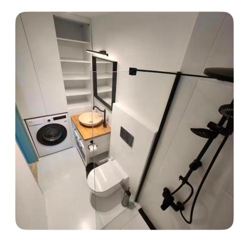 a small white kitchen with a toilet and a sink at Nunu GARDEN Urla in Urla