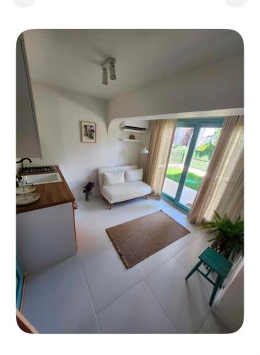 a living room with a white couch and a table at Nunu GARDEN Urla in Urla