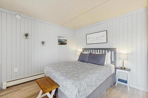 a small bedroom with a bed and a table at Salty Breeze Studio in Wells