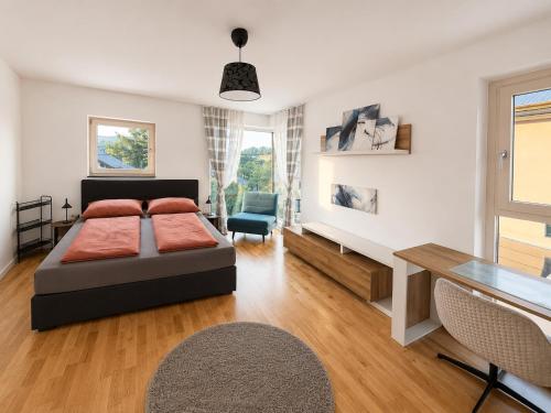 a bedroom with a bed and a desk at Luxury Villa Vienna in Mauerbach