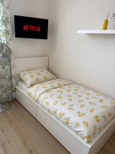 a bed in a room with a mattress with yellow butterflies at Centrum apartment in Brno