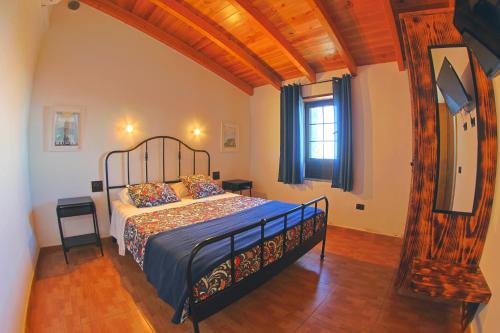 a bedroom with a bed with a blue comforter at Casa La Tabona in Frontera