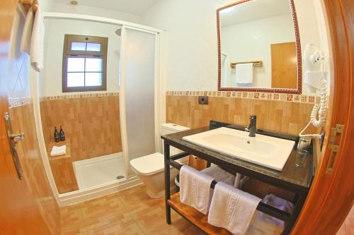 a bathroom with a sink and a shower at Casa La Tabona in Frontera