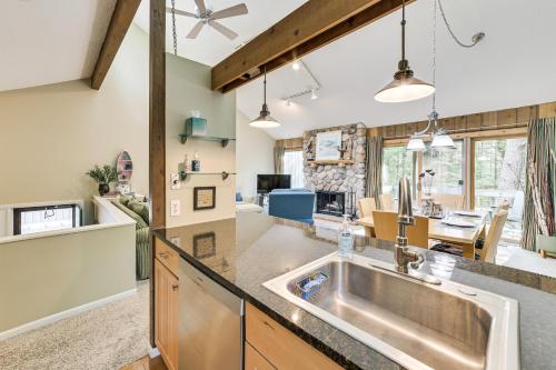 a kitchen with a sink and a living room at Only 8/22-8/29 Still Available for Summer 2026! in Harbor Springs