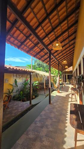 an outdoor patio with a table and a roof at Vila Rudá - Alter do Chão in Alter do Chao