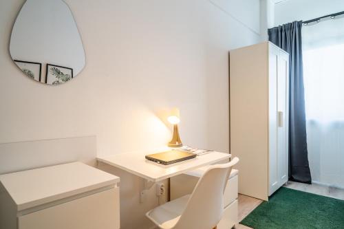 a white desk with a lamp and a mirror at D10 I shared bathrooms&kitchen in Garching bei München