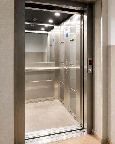 a walk in closet with a glass door at Kopernik Loft Jelenia Góra in Jelenia Góra