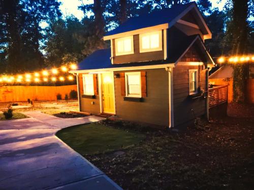 a small house with lights on top of it at Private Atlanta Tiny House with Mini Golf in Forest Park