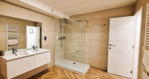 a bathroom with a sink and a shower at Durbuy House in Durbuy