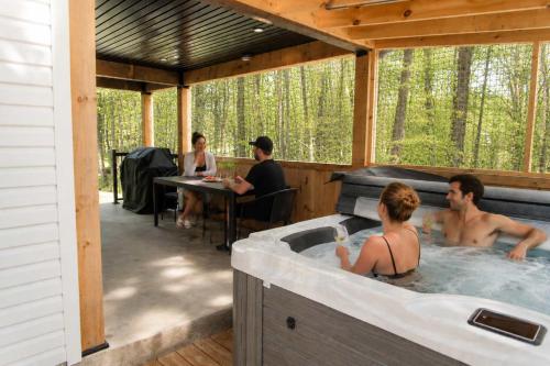 a group of people in a hot tub in a house at Lake Spa and Pool table - Le Gaia in Chertsey