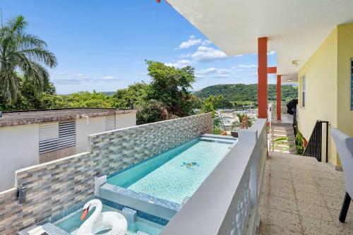 a swimming pool on the balcony of a house at Villa Marbella - Ocean Views & Private Pool in Luquillo