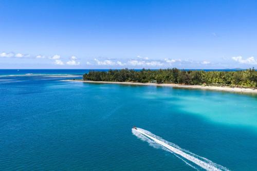 a boat in the middle of a large body of water at Villa Marbella - Ocean Views & Private Pool in Luquillo