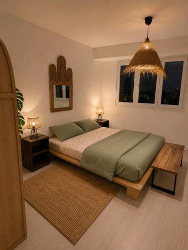 a bedroom with a large bed and two night stands at Downtown Terrace with panoramic view in Tourcoing