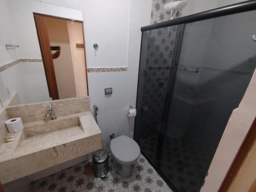 a bathroom with a sink and a toilet and a shower at Pouso do parente in Pirenópolis