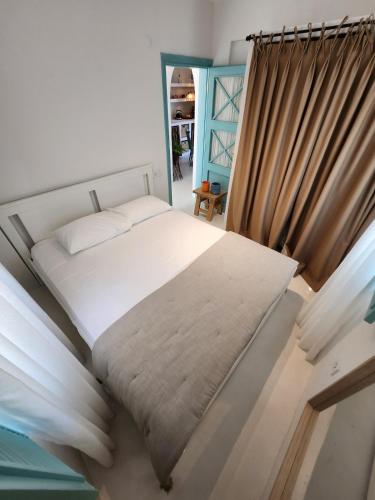 a bedroom with a bed and a curtain at Nunu HOUSE Urla in Urla