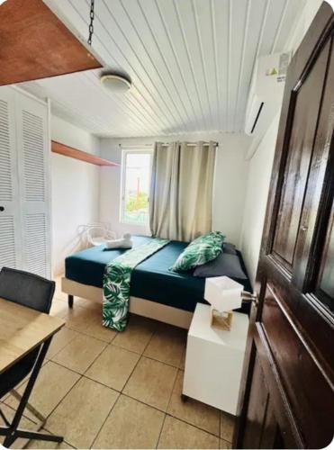 a bedroom with a bed in a room with a window at F2 Tahiti Lagoon Stays in Punaauia